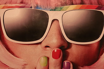 Close-up of woman with pink hair and colorful nails