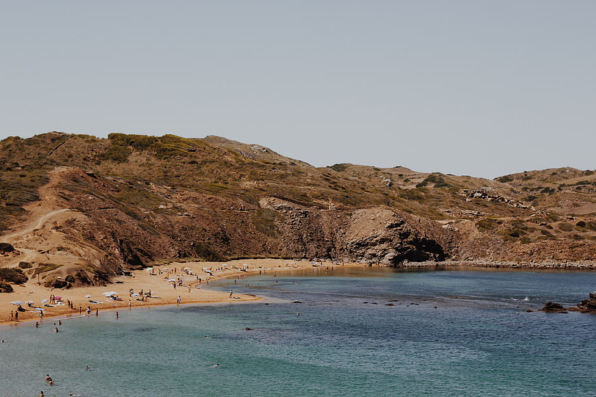 Scenic Mediterranean Beach with Turquoise Water and Arid Hills