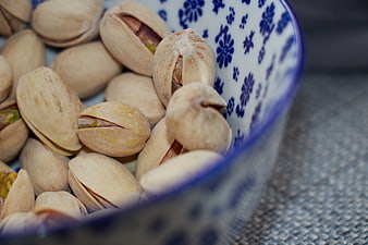Close-up of pistachios in a blue and white patterned bowl
