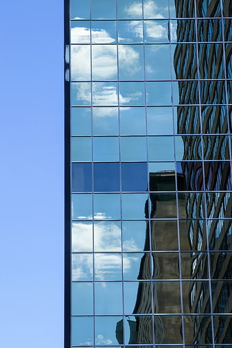 Modern Glass Skyscraper with Cloud Reflections