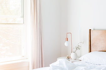 Bright Minimalist Bedroom with Wooden Bed and Copper Lamp