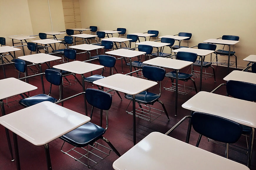 Empty Classroom with Rows of Desks and Chairs
