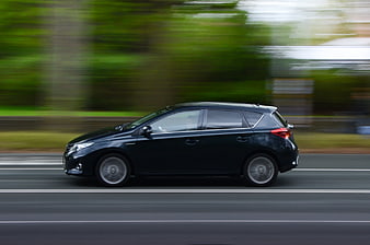 Black Hatchback Car Driving Fast on Road
