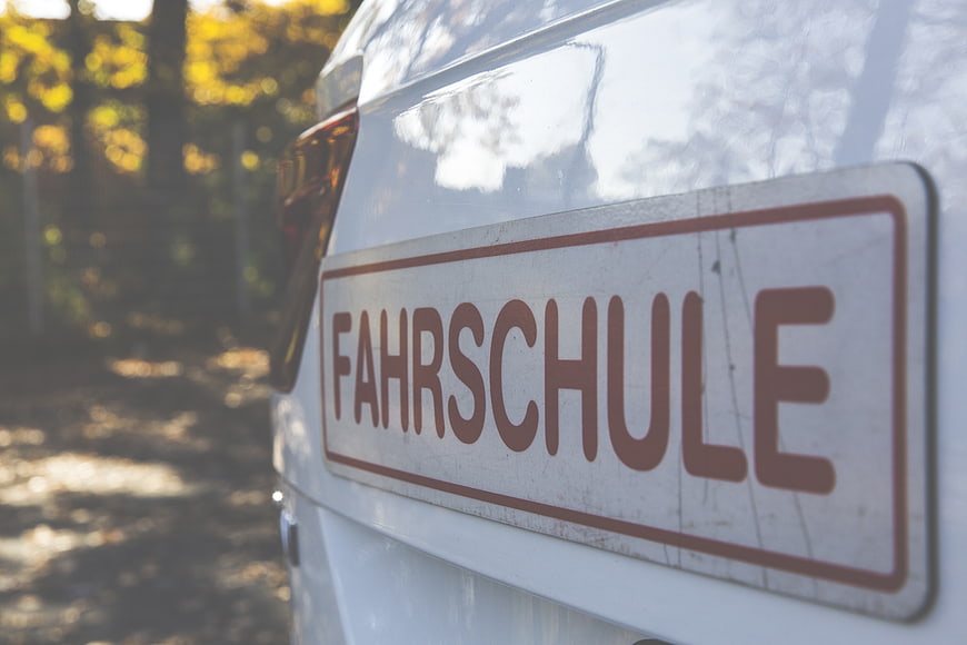 Close-up of Fahrschule Driving School Sign on White Car