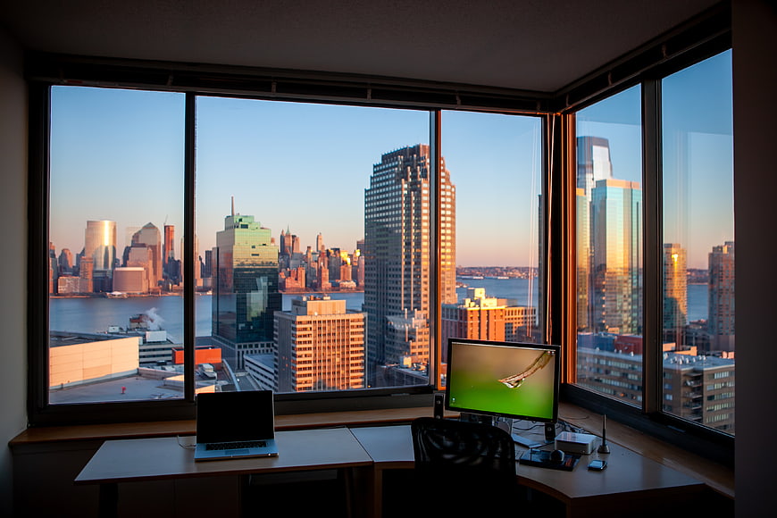 Modern Home Office with City Skyline View at Sunset