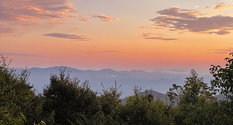 Serene Mountain Landscape at Sunset with Pink Sky