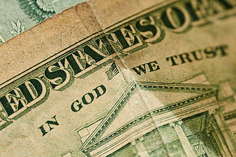 Close-up of worn US dollar bill with In God We Trust text