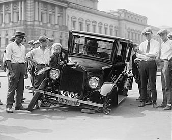 Vintage Black and White Photo of Damaged 1920s Car