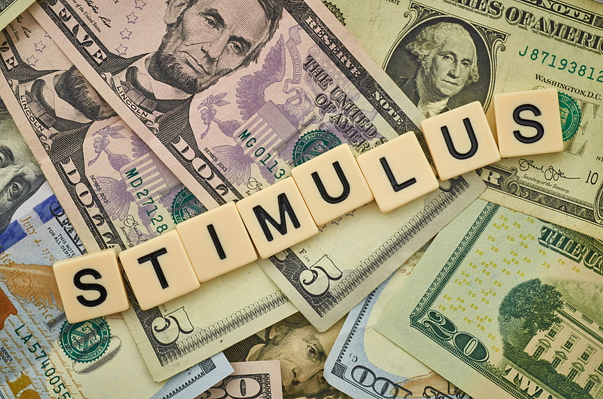 Stimulus word spelled with letter tiles on US dollar bills
