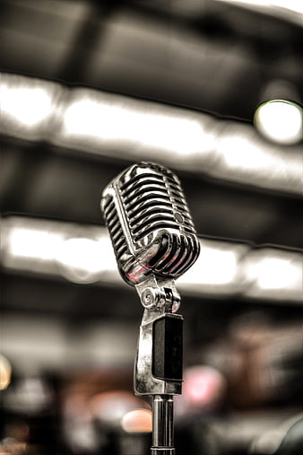 Vintage Silver Microphone on Stage with Blurred Lights