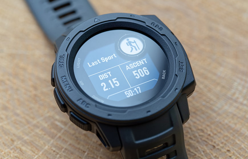 Close-up of black GPS hiking smartwatch on wooden surface