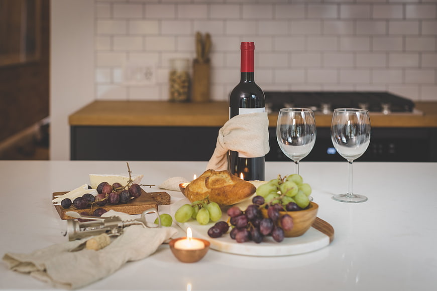 Romantic wine and cheese dinner setup in modern kitchen