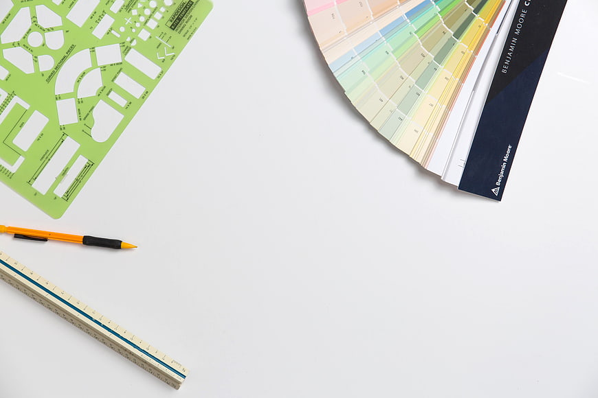 Interior design tools flat lay with color swatches and stencil