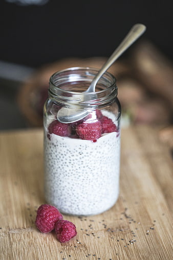 Raspberry Chia Pudding in Glass Jar on Wooden Board