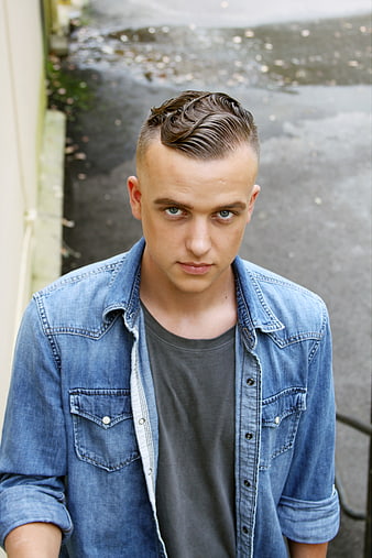 Portrait of Young Man with Slicked Back Hair in Denim Shirt