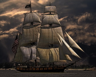Historic Tall Ship Sailing Under Dramatic Stormy Sky