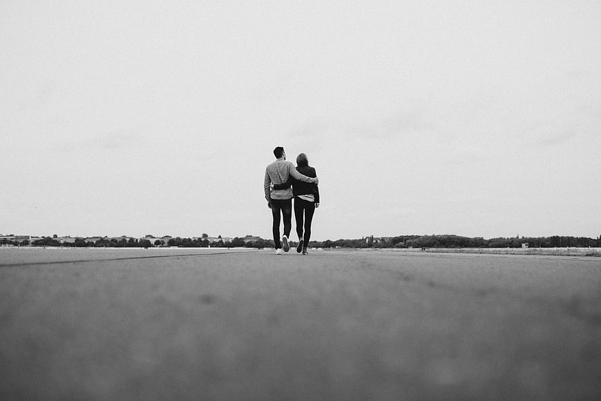 Couple Walking Away on Open Road in Black and White