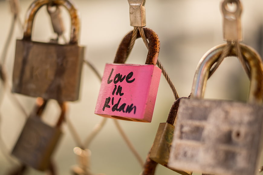 Pink Love Lock with Handwritten Text on Rusty Fence