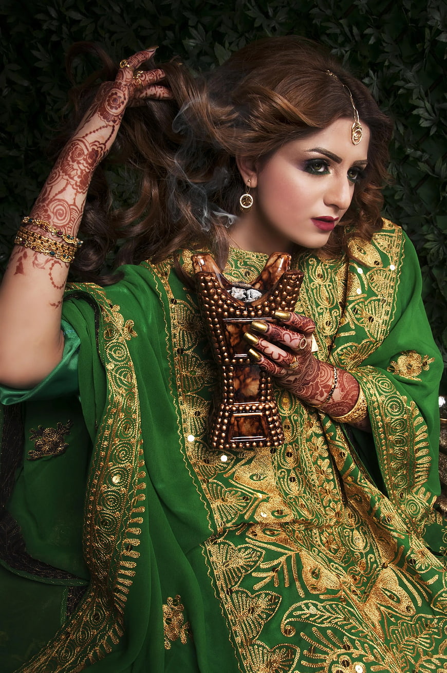 Woman in Green Embroidered Dress with Henna and Incense