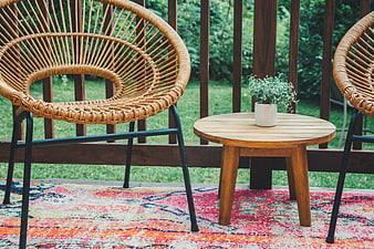Cozy Outdoor Patio with Wicker Chairs and Wooden Table