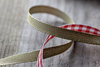 Gold and Red Plaid Ribbon on Wooden Background