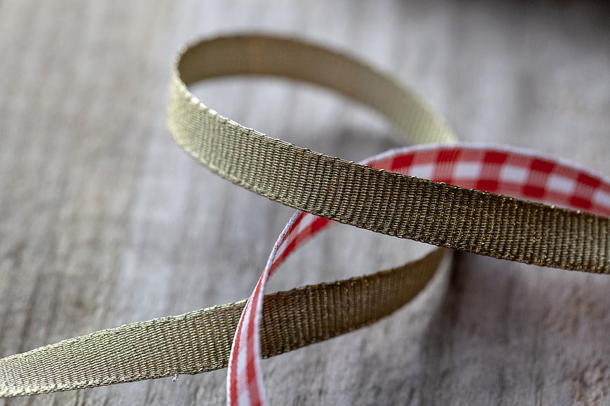 Gold and Red Plaid Ribbon on Wooden Background