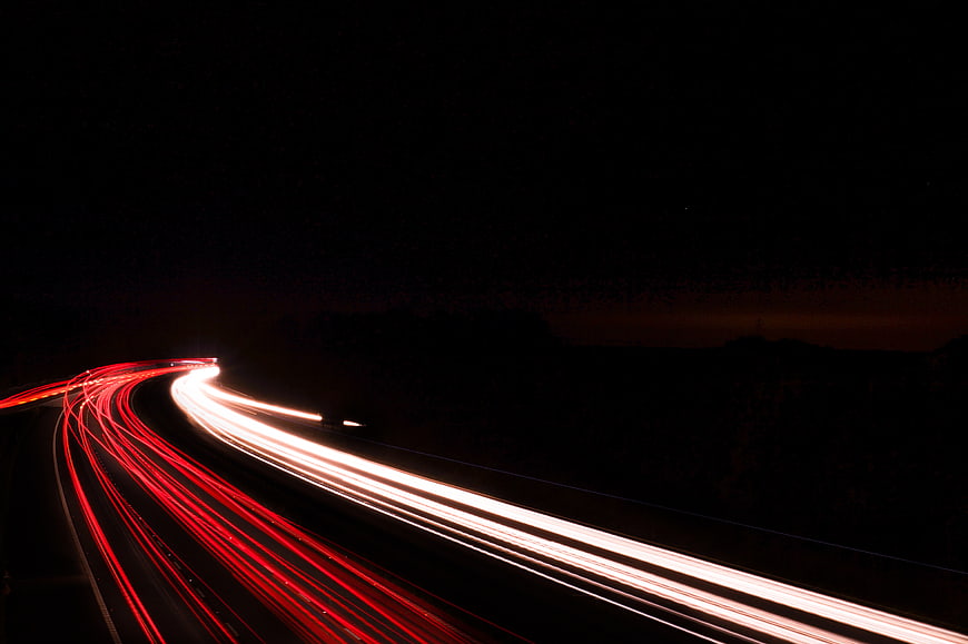 Long exposure light trails on a dark highway at night