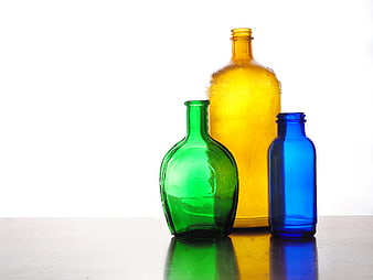 Vintage Colored Glass Bottles on White Background
