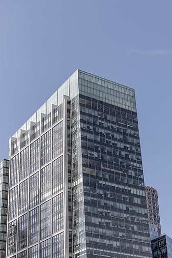 Modern Glass Office Building Against Blue Sky