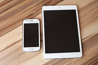 White Samsung Smartphone and Tablet on Wooden Surface