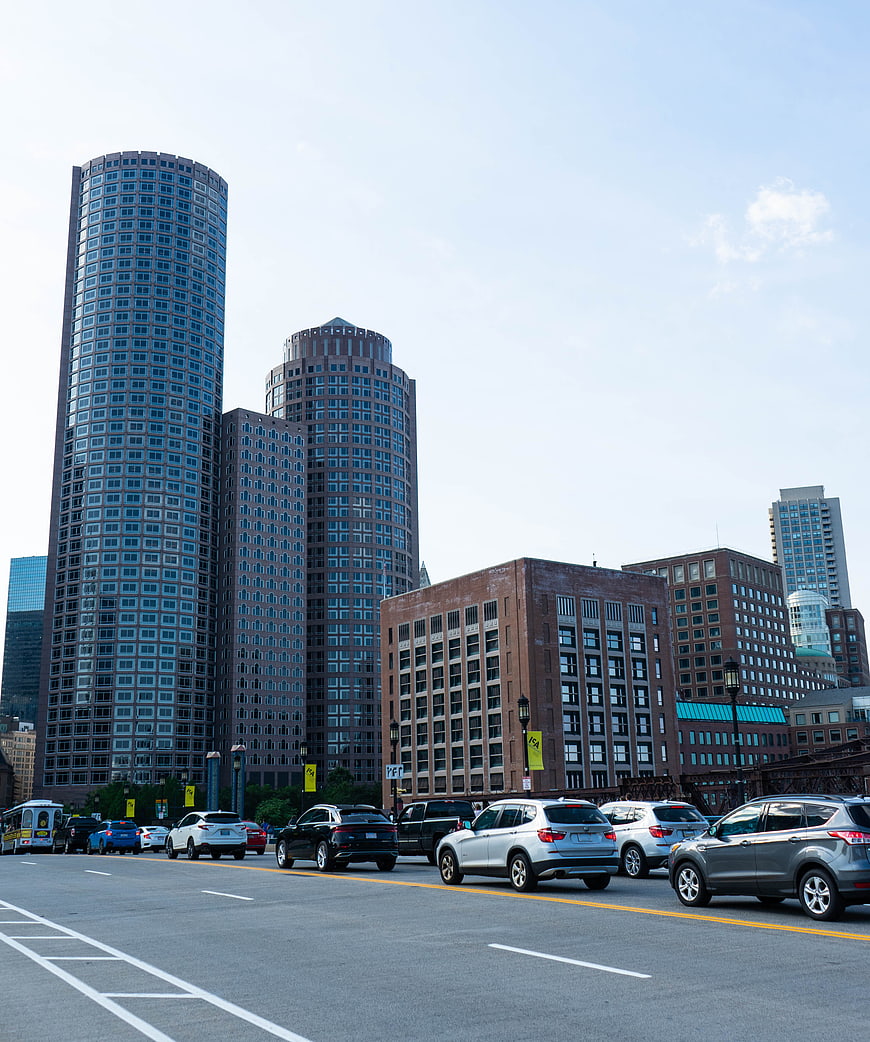 Modern city skyline with traffic on urban street