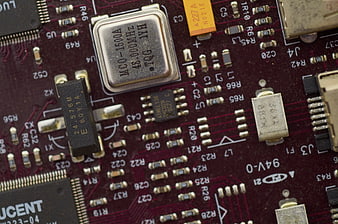 Close-up of red electronic circuit board with microchips