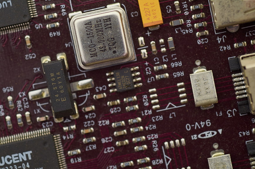 Close-up of red electronic circuit board with microchips