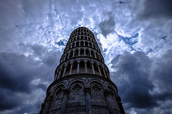 Low angle view of Leaning Tower of Pisa against dramatic cloudy sky