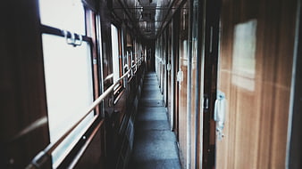 Empty vintage train corridor with wooden doors and windows