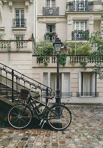 Vintage Bicycle Parked on Cobblestone Street in Paris