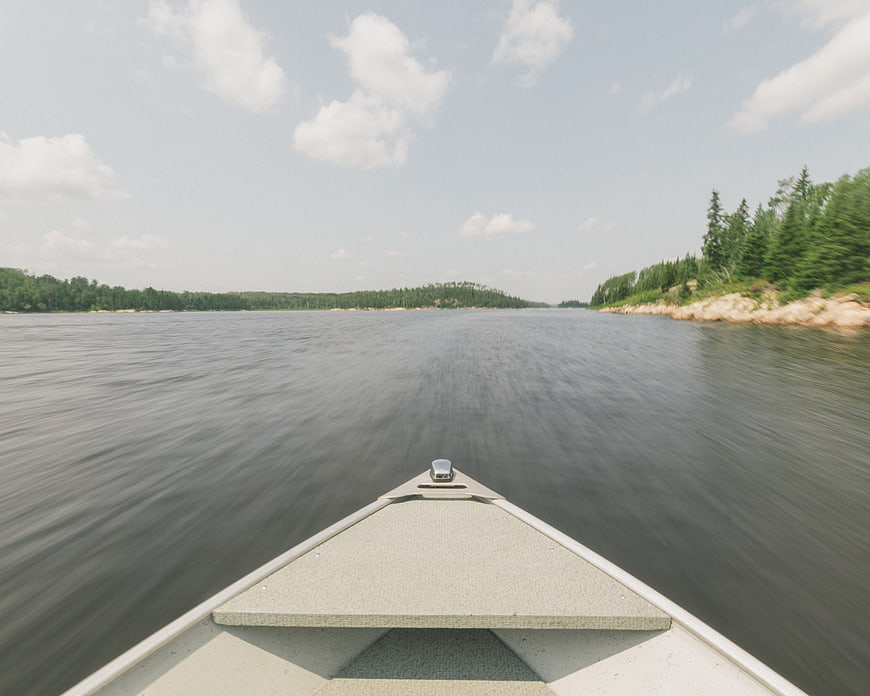 First-person view from bow of boat on calm lake