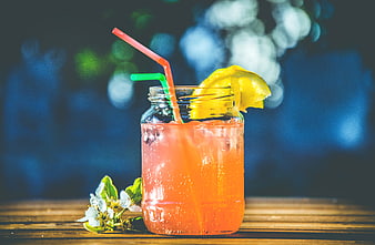 Refreshing Pink Cocktail in Mason Jar with Lemon and Straws