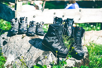 Black hiking boots arranged on a rock in nature