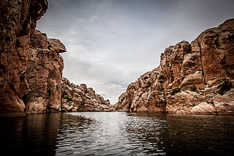 Dramatic Canyon Landscape with Calm Water and Rocky Cliffs