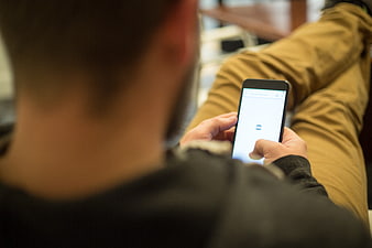Man using smartphone while sitting on couch
