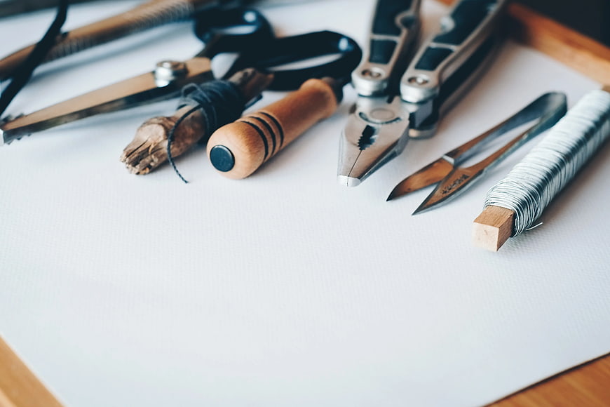Jewelry Making Tools and Wire on White Paper
