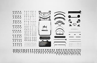 Disassembled vintage typewriter parts arranged in flat lay