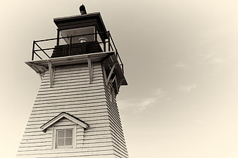 Low angle view of vintage wooden lighthouse tower against sky