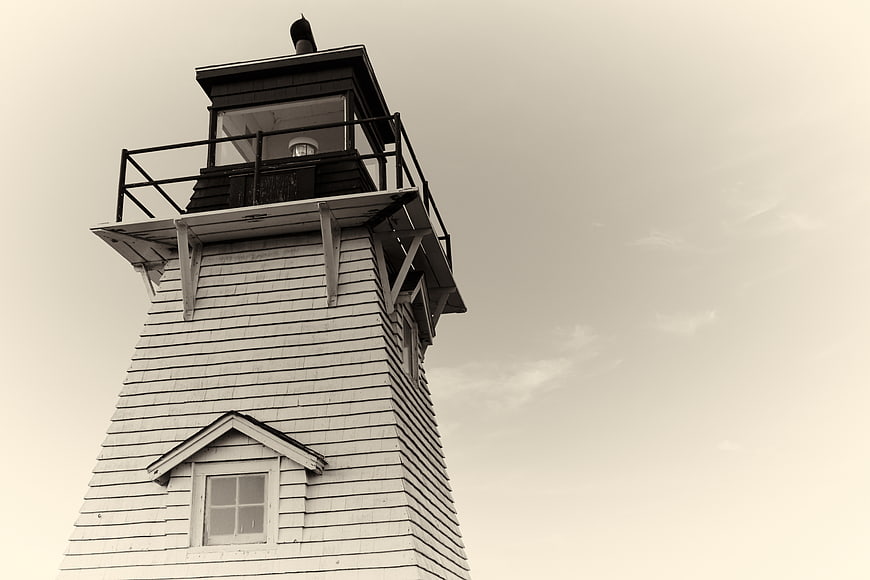 Low angle view of vintage wooden lighthouse tower against sky