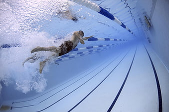 Underwater shot of male swimmer in pool lane