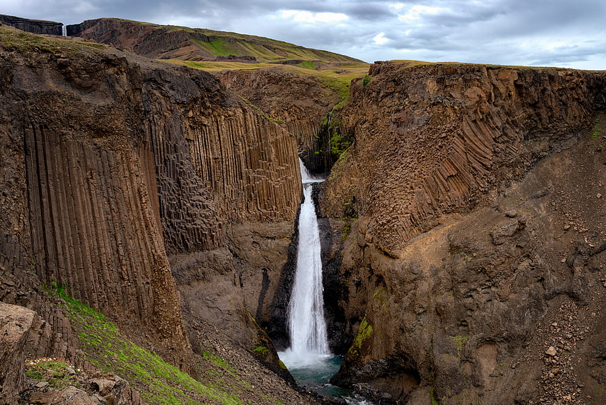 Stunning waterfall cascading through basalt columns in Iceland