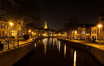 Night View of Illuminated Canal in European City