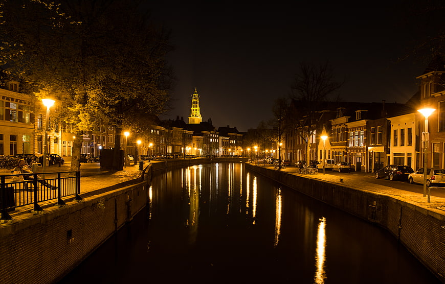 Night View of Illuminated Canal in European City