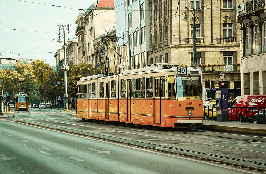 Vintage orange tram on city street in Budapest